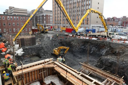 Pouring the building’s first walls, with a 42m pump truck. February 24