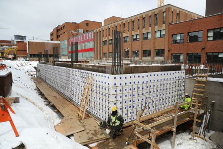 The foundation walls are formed with a preinsulated system called Thermomass. March 30