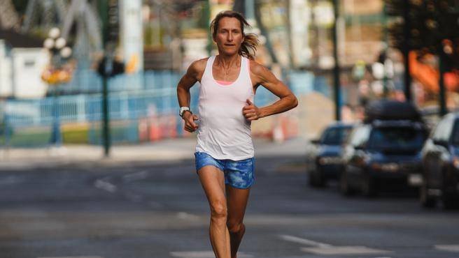 Lucy Smith runs along Johnson Street in Victoria, BC.
